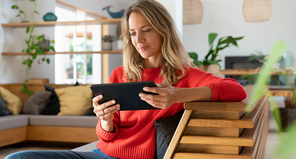 Member using SF Fire CU online banking on a tablet
